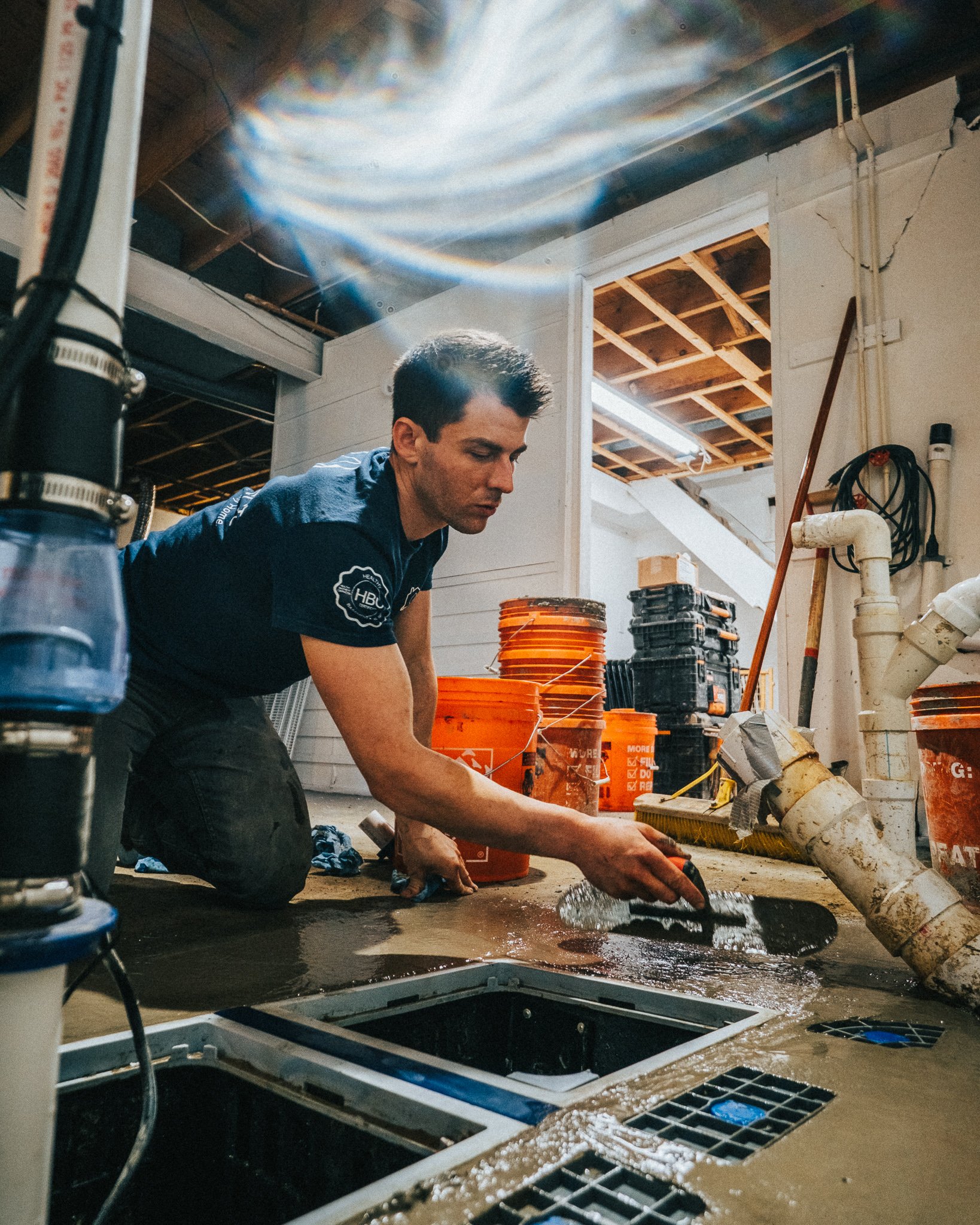 man applying waterproofing solution with a hand tool